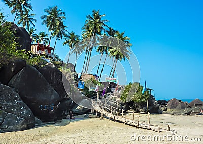 Bright traditional bungalow, standing on a high mountain, against the backdrop of palm trees and bright blue sky, Palolem beach Editorial Stock Photo